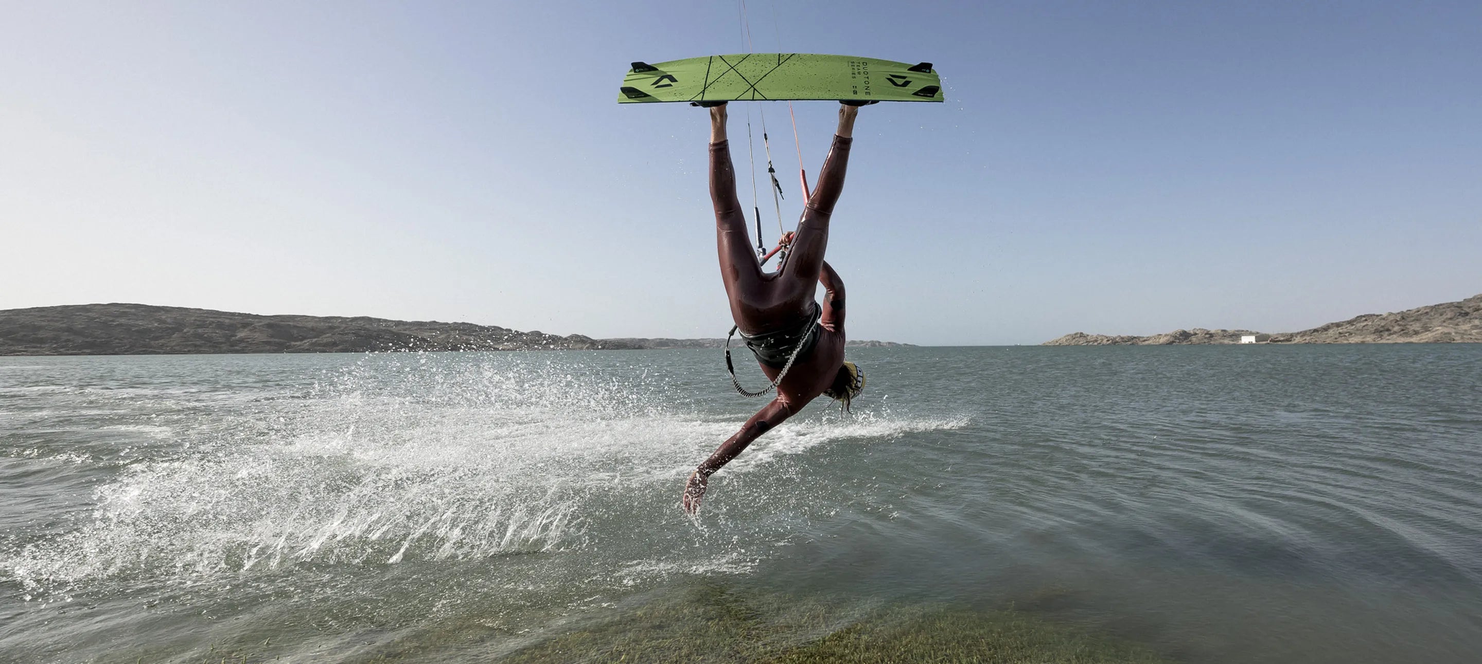 Kitesurfer on water doing trick